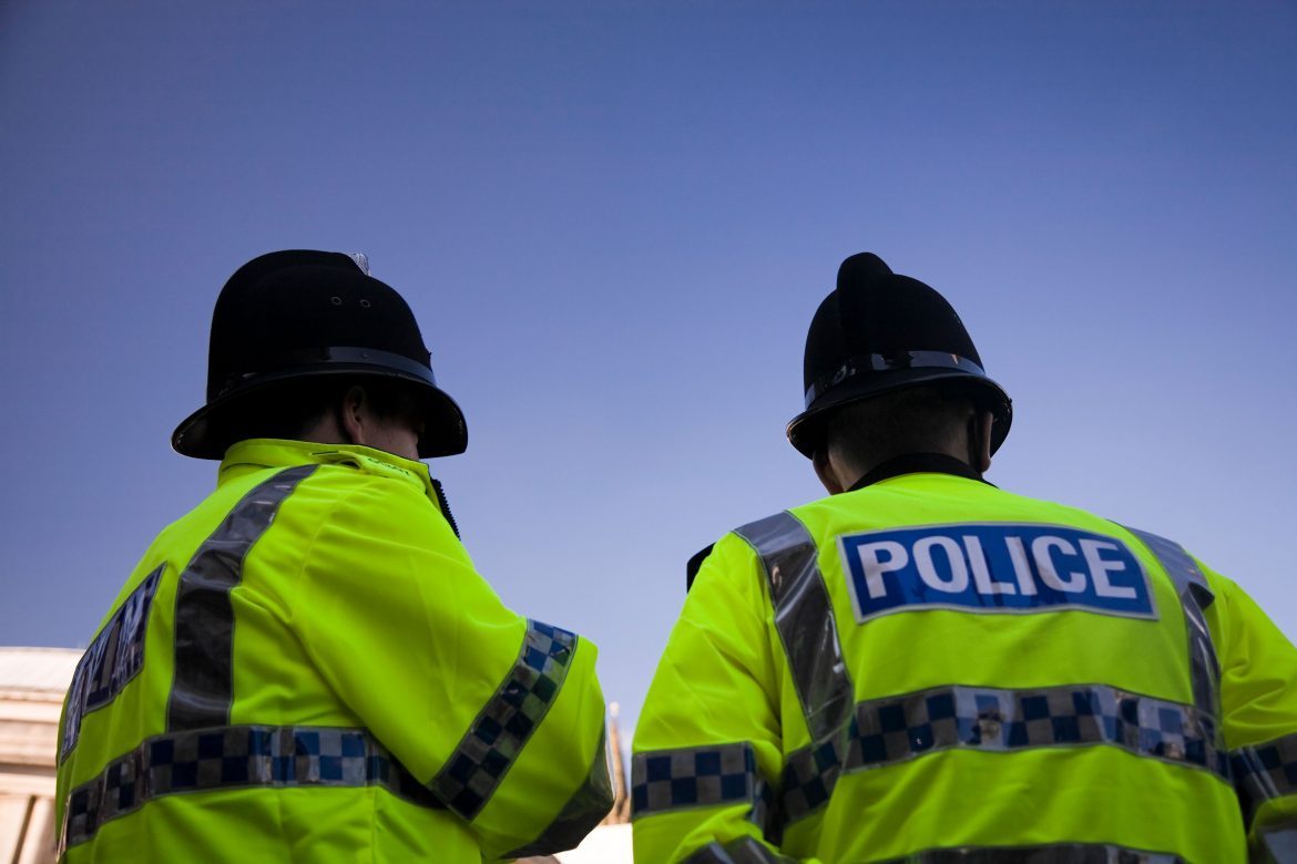 Image of the back of two police officers
