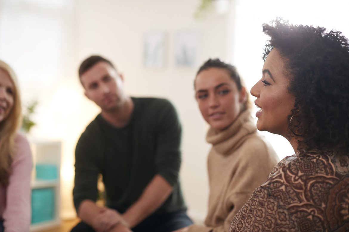 A man and 2 women at a meeting