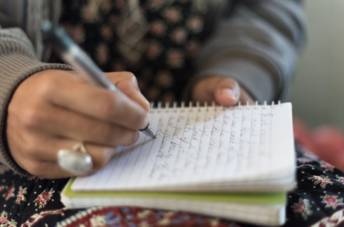 Woman writes notes in a book