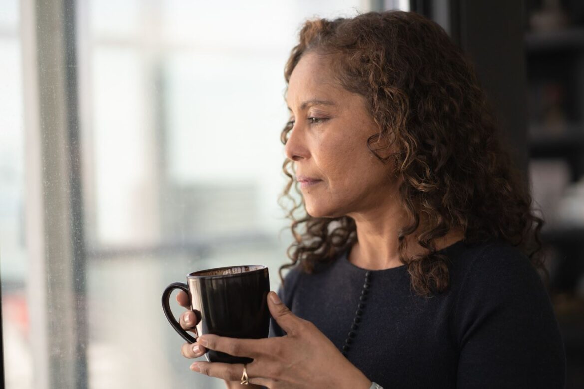 Woman looks out window
