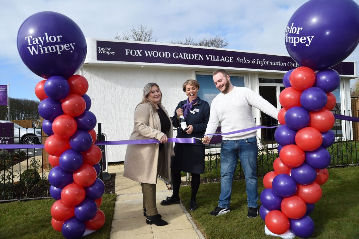 First couple to reserve a new home at Taylor Wimpey's new development at Halsnead Garden Village cut the ribbon at the new sales office