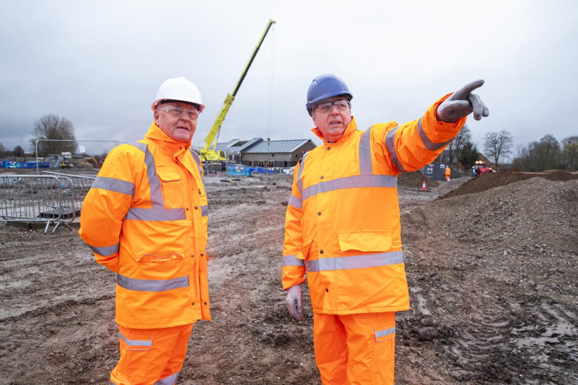 Cllr Tony Brennan and Metro Mayor Steve Rotheram look at the progress so far on the new Headbolt Lane station site.