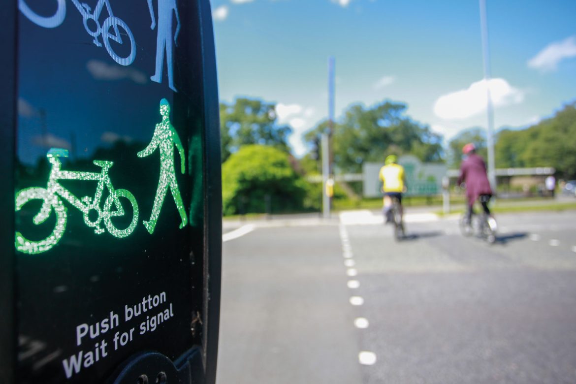 Image of people on bike crossing road