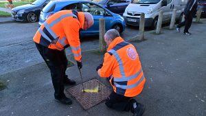 Environmental Health officers carrying out sewer rat baiting in Page Moss