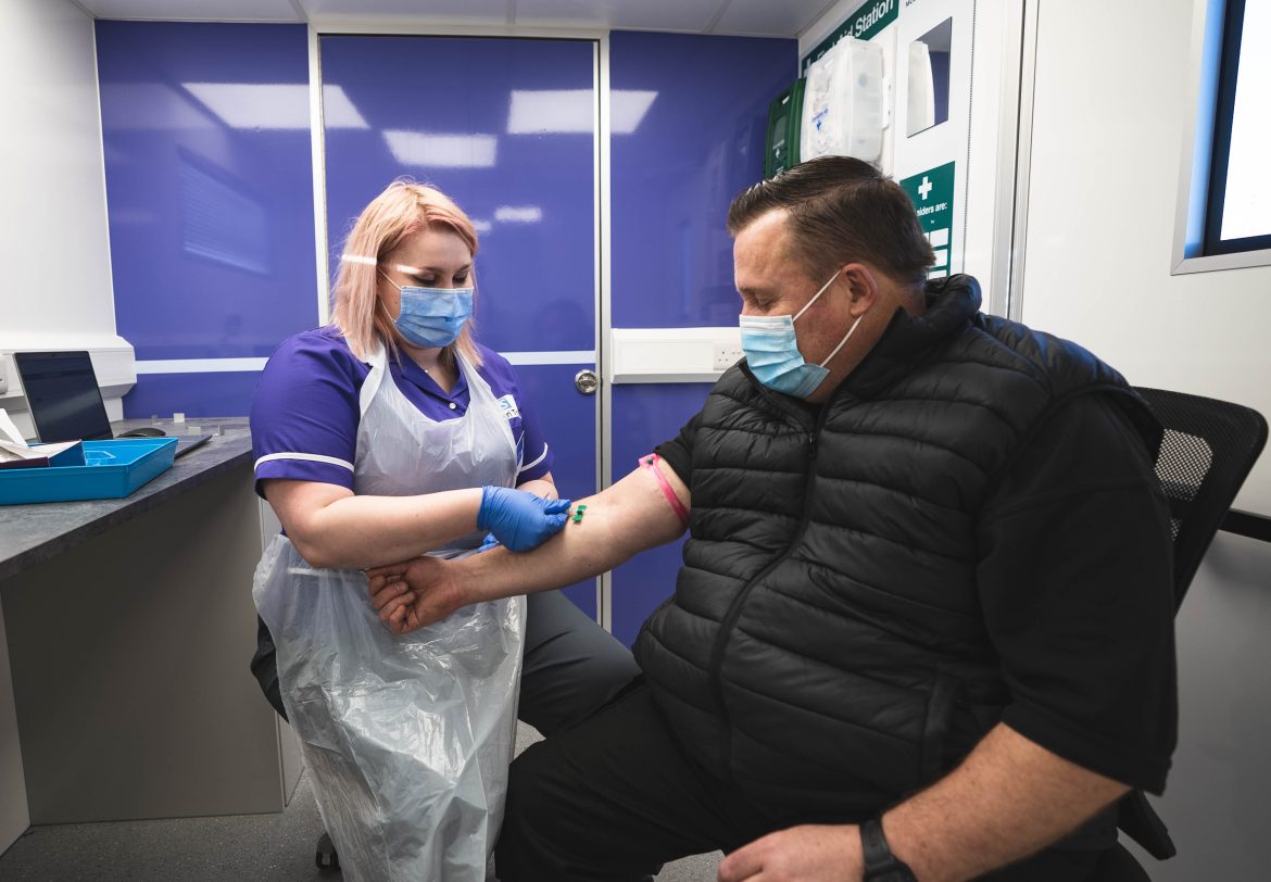 Man having blood taken by a nurser as part of NHS-Galleri trial.