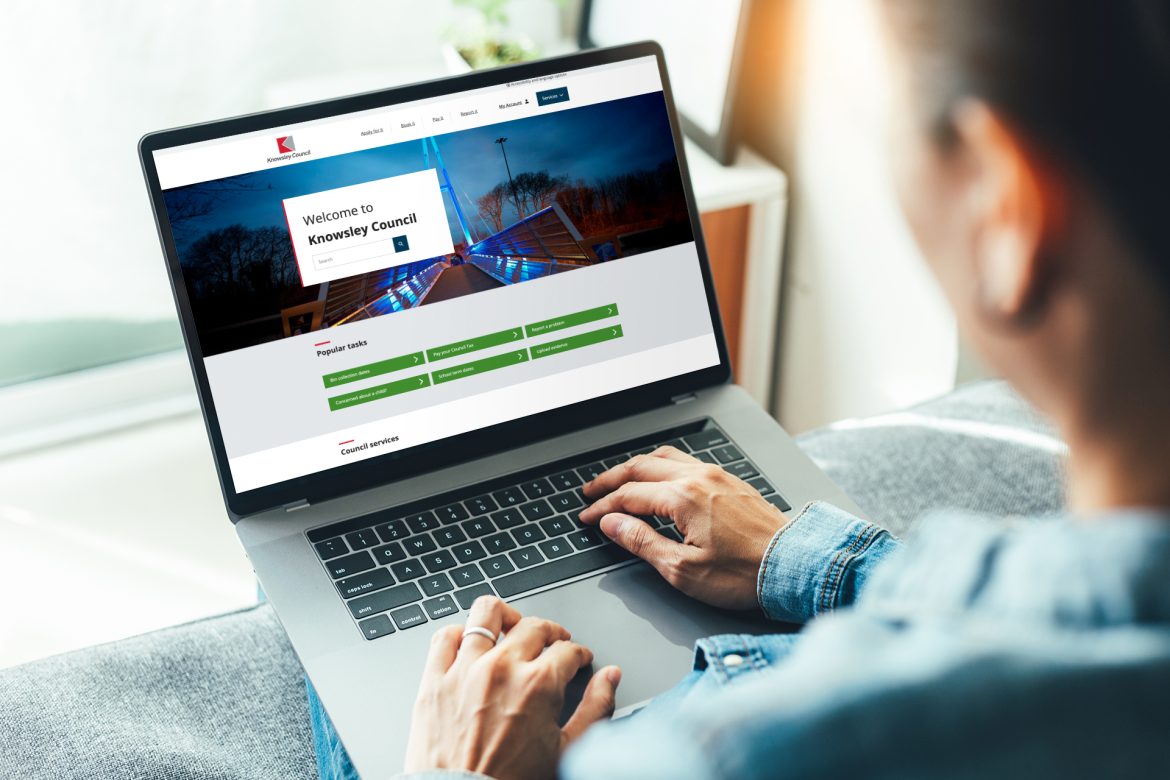 View over man's shoulder as they browse the new Knowsley council website