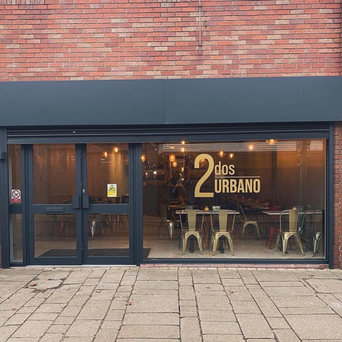 The outside of the new 2dos Urbano, with tables and chairs visible inside