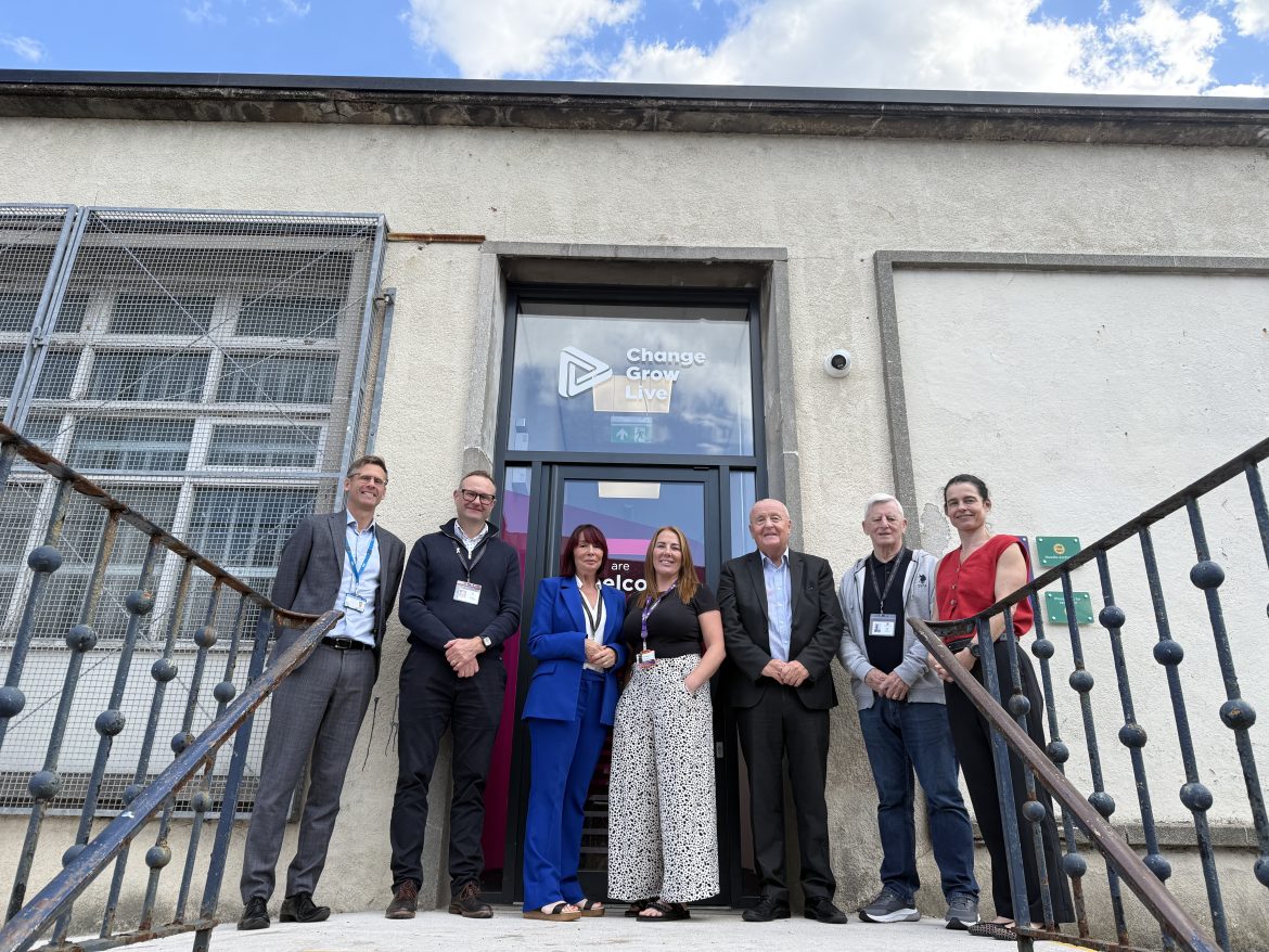 A group of people stand in front of a building