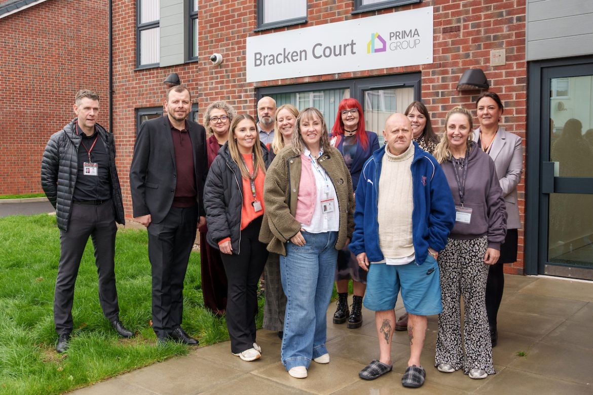 group of adults standing in front of building